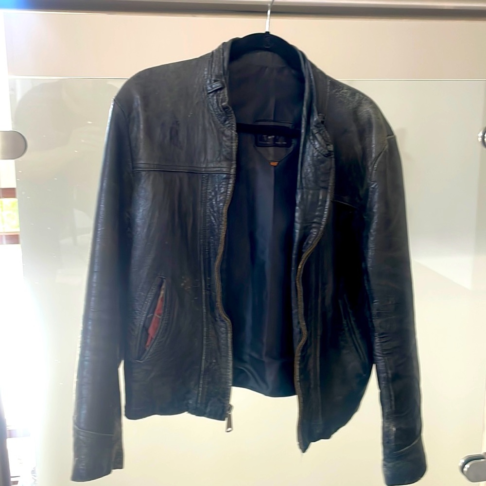 Tony’s brand leather motorcycle jacket. Fits tight. Zipper works. Inside pocket.